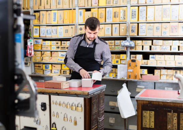 istock Man seller sorting boxes with door details 854414218