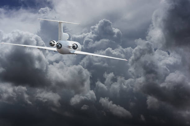 Civil airliner head to thunderstorm clouds stock photo