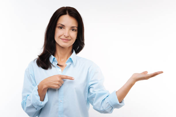 istock Pleasant woman stretching out hand and pointing at it 854414768