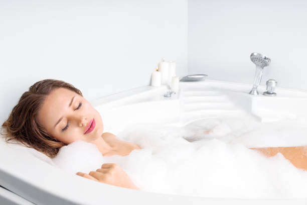 istock Young woman enjoying bathing in bathtub 854414840