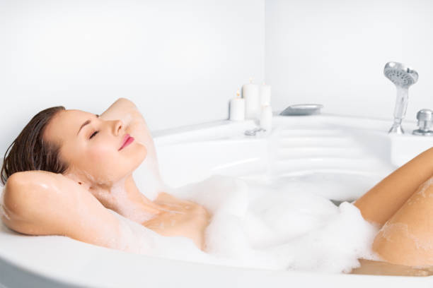 istock Young woman enjoying bathing in bathtub 854414852