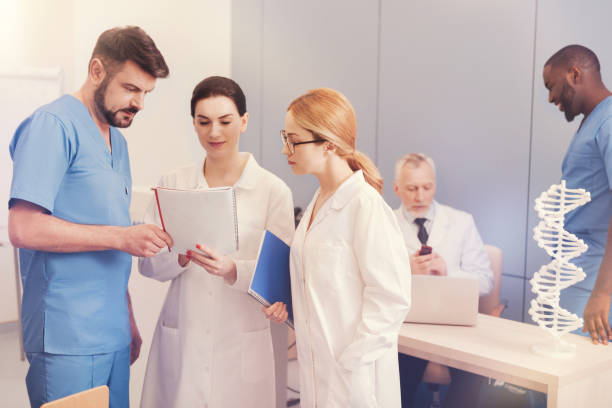istock Group of attentive interns discussing important information 854415508