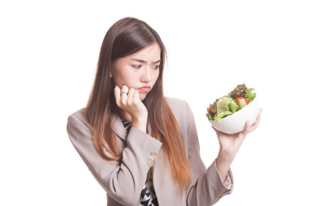 istock Asian woman hate salad. 854417918
