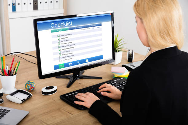 istock Businesswoman Filling Checklist Form On Computer 854418958