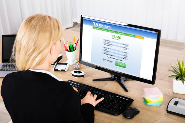 istock Businesswoman Calculating Tax On Computer 854419346