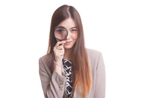 istock Young Asian woman with a magnifying glass. 854421950