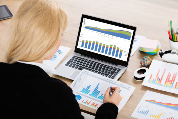 istock Businesswoman Analyzing Financial Graphs 854422458