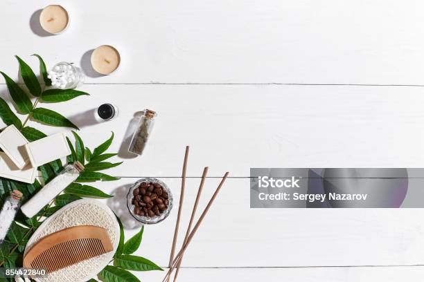 Natural Handmade Soaps With Coffee Beans Sea Salt Loofah Brown Towel And Green Leaves On White Wooden Background Stock Photo - Download Image Now