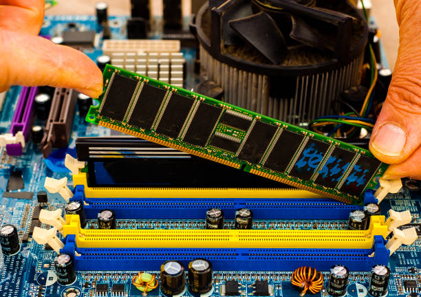 istock Put computer memory DDR RAM in the slot of motherboard 854424076