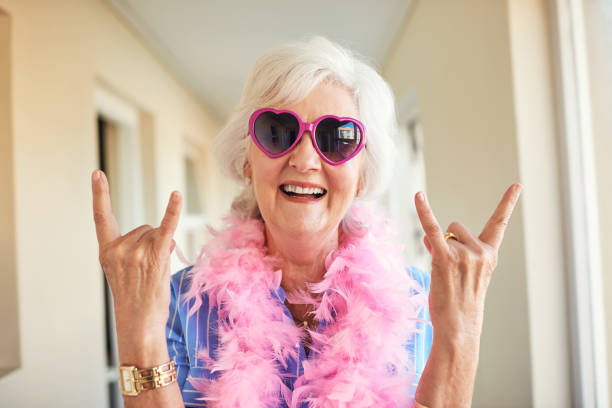 Rock on no matter the age Cropped shot of a senior woman at home horn sign stock pictures, royalty-free photos & images