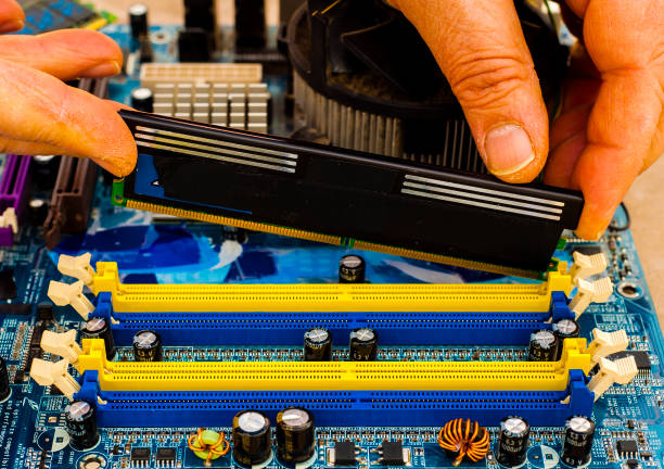 istock Put computer memory DDR RAM in the slot of motherboard 854428246