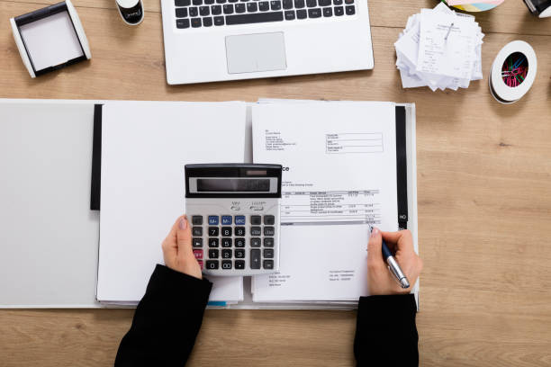 istock Businesswoman Calculating Invoice Using Calculator 854429530