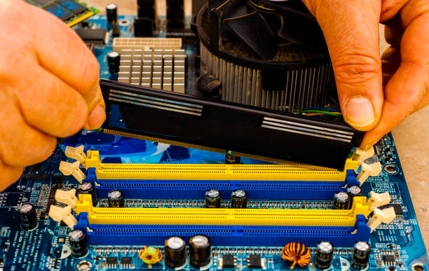 istock Put computer memory DDR RAM in the slot of motherboard 854429666