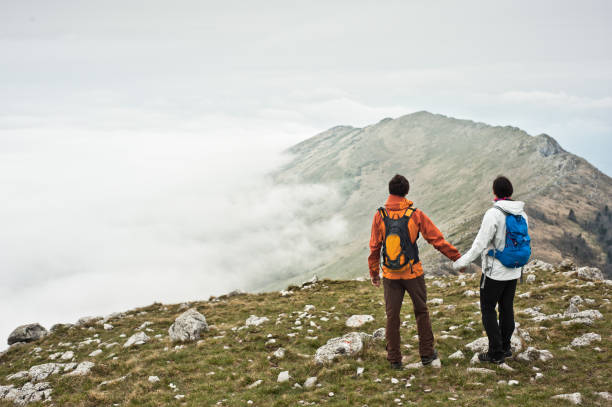 istock Young couple holding hands in the mountains. 854430580