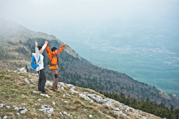 istock Young couple holding hands in the mountains. 854430712
