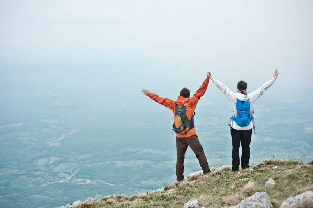 istock Young couple holding hands in the mountains. 854431106