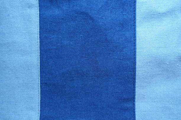 istock Dark vertical stripe sewn to sky blue linen 854435722