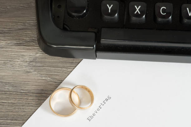 istock A marriage contract, typewriter and wedding rings 854442270