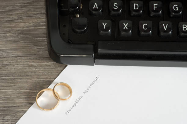 istock A marriage contract, typewriter and two wedding rings 854442446