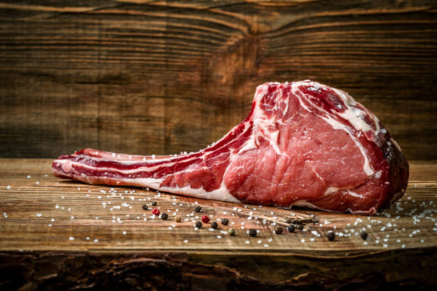 istock Dry aged raw tomahawk beef steak with ingredients for grilling 854445558