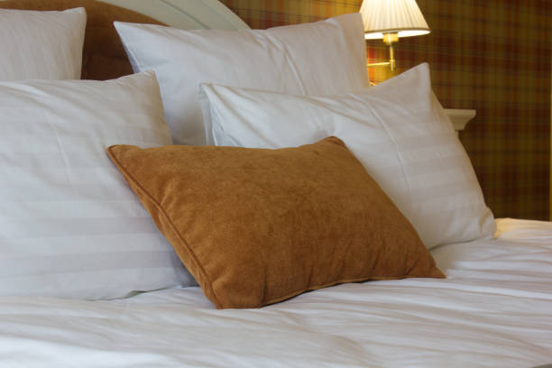 istock Pillows on bed in hotel room. White and brown one. 854447322