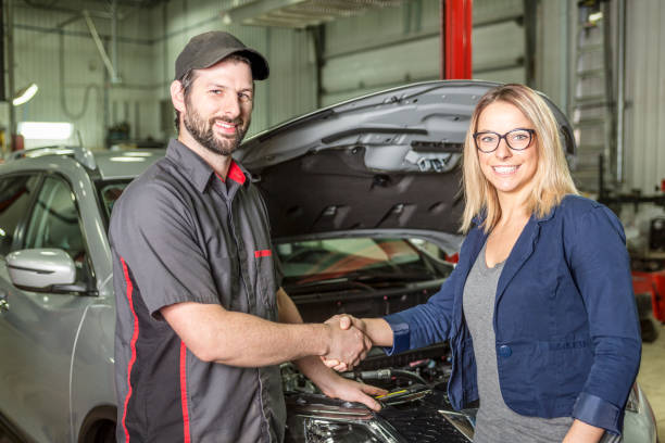 istock auto mechanic and female customer in garage 854447478