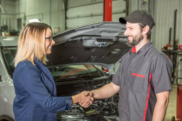 istock auto mechanic and female customer in garage 854448988