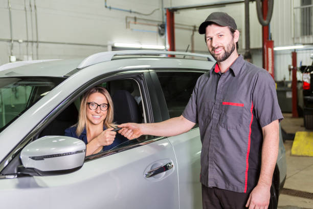istock auto mechanic and female customer in garage 854449778