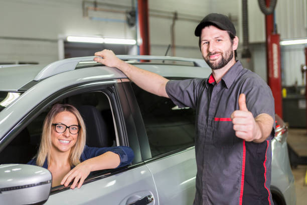 istock auto mechanic and female customer in garage 854449874
