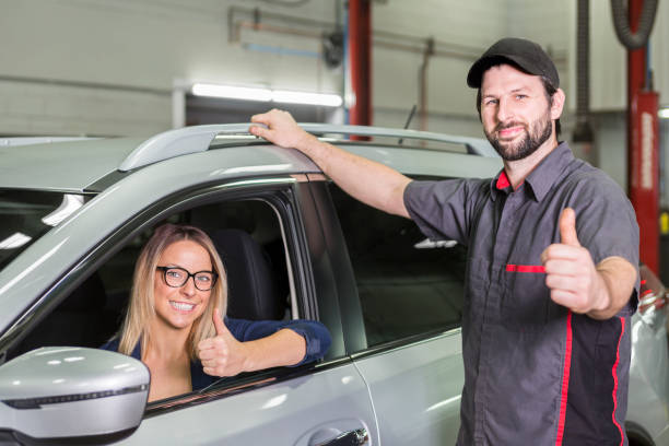 istock auto mechanic and female customer in garage 854449934