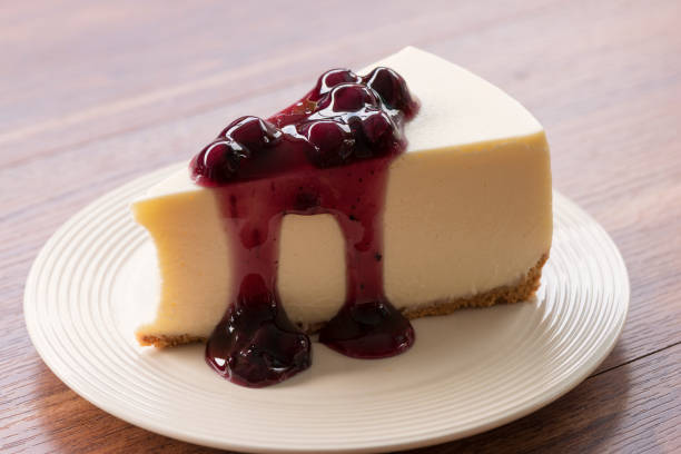 istock Blueberry cream cheesecake in white plate on wood table 854450544