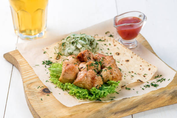 plato principal de carne de pollo con verduras y salsa en una tabla de madera - healthy eating food and drink raw leek fotografías e imágenes de stock