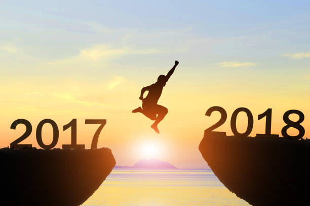 istock Men jump new year 2017 to 2018 854450716