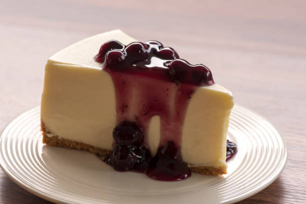istock Blueberry cream cheesecake in white plate on wood table 854450888