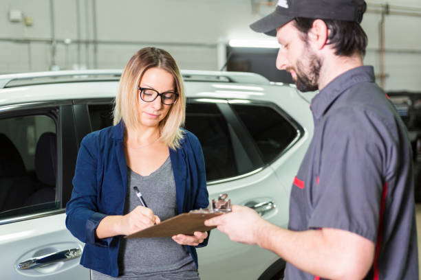 istock auto mechanic and female customer in garage 854451048