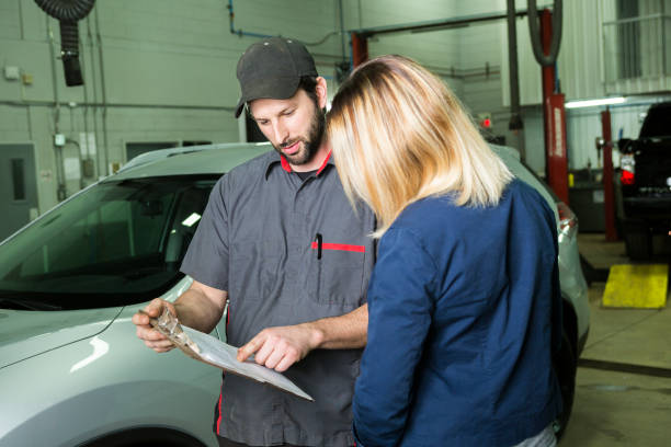 istock auto mechanic and female customer in garage 854452022