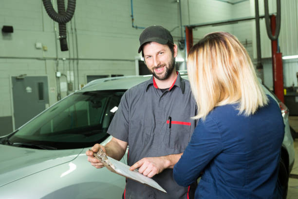 istock auto mechanic and female customer in garage 854452986