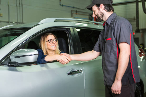 istock auto mechanic and female customer in garage 854456472