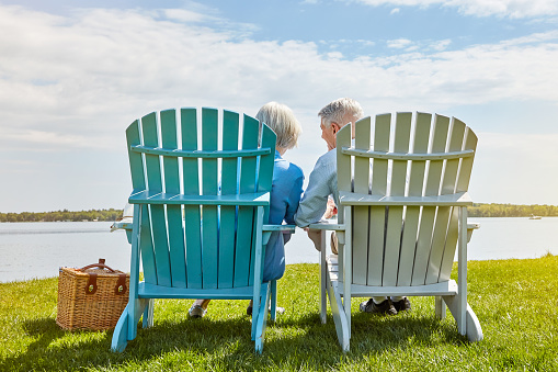 Shot of an affectionate senior couple relaxing on chairs together outside