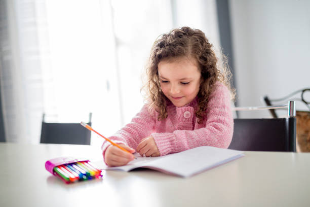 istock girl writing with pen at the table 854458058
