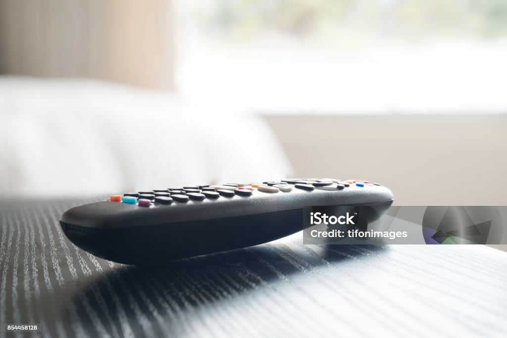 TV Remote control Close up of the remote control of a smart TV in the night table of a bedroom "n Remote Control Stock Photo