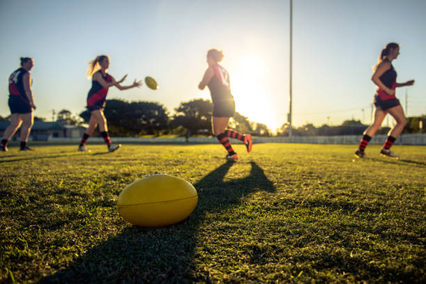 Go for the whole nine yards! Shot of a team of woman playing a game of football sports training australia stock pictures, royalty-free photos & images
