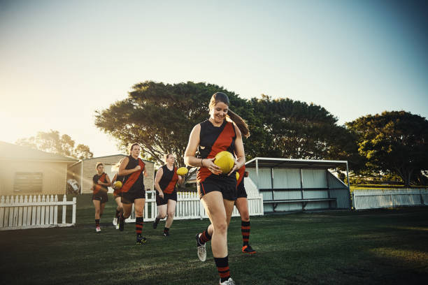 Pre-season practice Shot of a team of woman playing a game of football sports training australia stock pictures, royalty-free photos & images