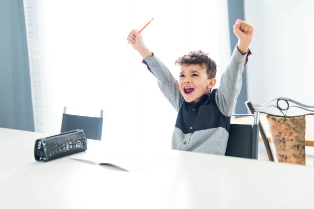 istock Cute little boy doing homework at home 854461384
