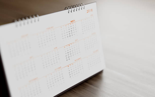 istock White 2018 Calendar Standing On  Brown Wood Surface 854461806