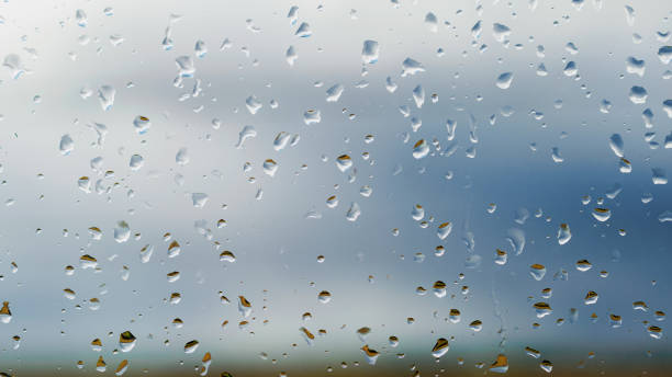 istock Drops of rain on blue glass background 854467954