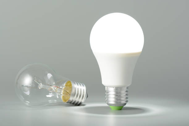 Glowing led lamp and incandescent bulb stock photo