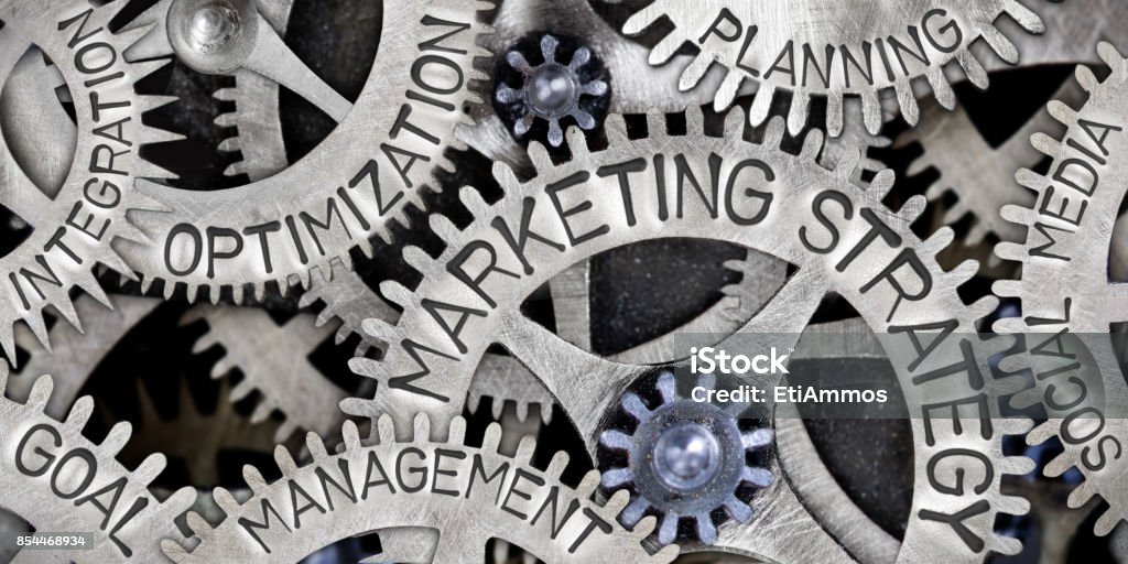 Metal Wheel Concept Macro photo of tooth wheel mechanism with ONLINE MARKETING letters imprinted on metal surface Marketing Stock Photo