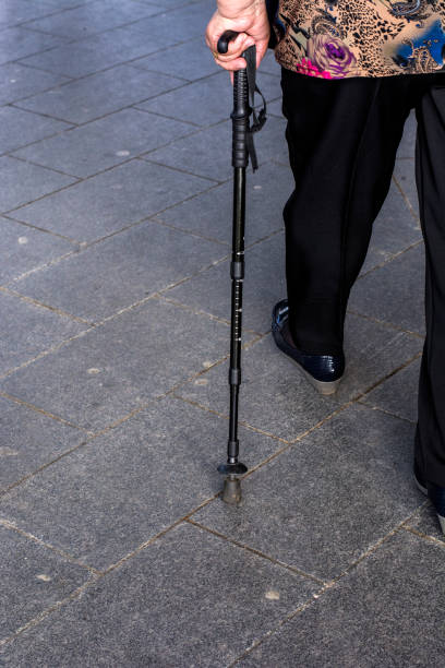 istock Lonely pensioner woman walking with stick 854468970