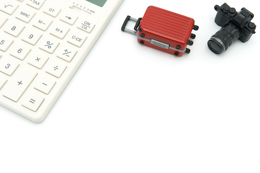 Calculator red luggage models and camera models Put on a white background Have space to enter the text below. Communicate travel expenses. tourism copy space